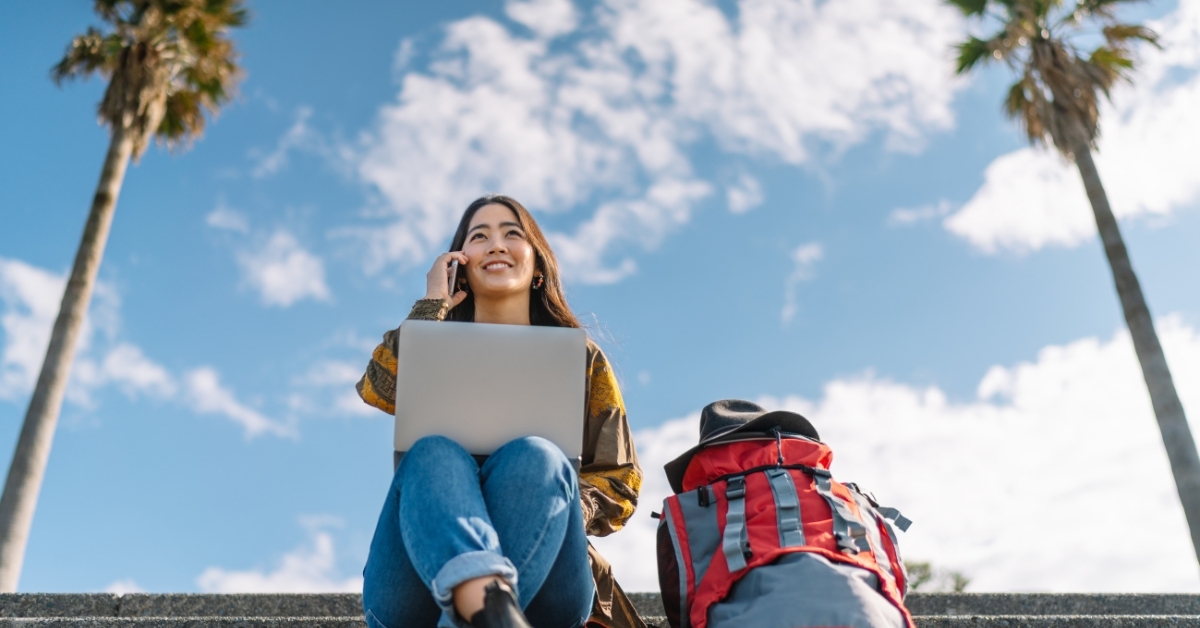 Woman with laptop and backback